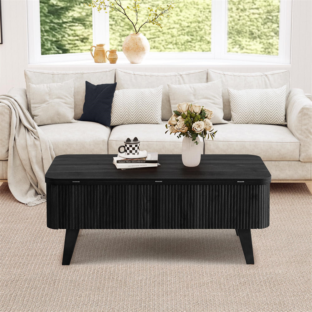 Living room with a black coffee table, white sofa, and decorative items.